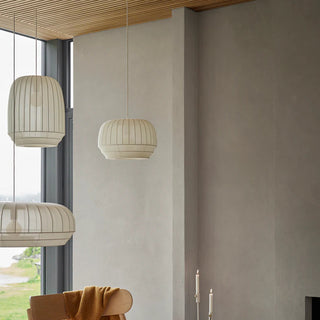 Modern interior with pendant lights, a chair, and a fireplace.