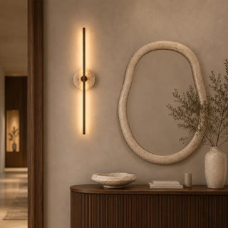 Telbix Rimini Vintage Brass wall light illuminated beside an organic mirror
