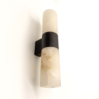 Wall-mounted light fixture with beige marble-like finish and black frame on a white background