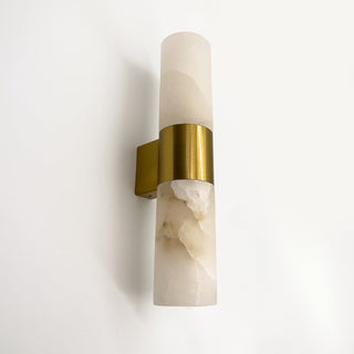 Wall sconce with marble base and gold accent on a white background