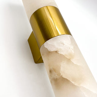 Decorative wall sconce with gold and marble design on a white background