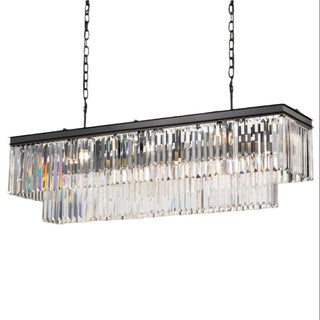 Rectangular crystal chandelier hanging against a gray wall