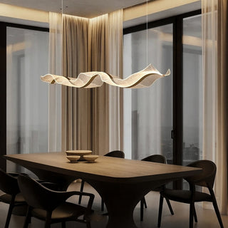 Modern dining room with a wavy pendant light fixture.