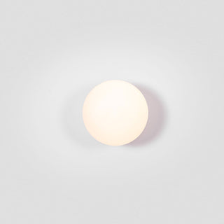 Round white light fixture on a light gray background