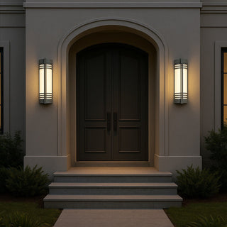 Elegant exterior of a house with a dark wooden door and wall lights on a dark night.
