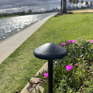Telbix SCAPE Post Light Black – installed among greenery