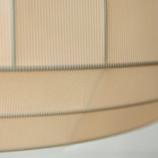 Close-up of a beige fabric with a subtle pattern on a white background