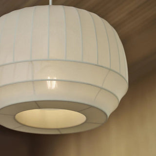 White pendant light with ribbed design on a neutral background