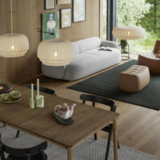 Modern living room with a dining table, chairs, and decorative elements.