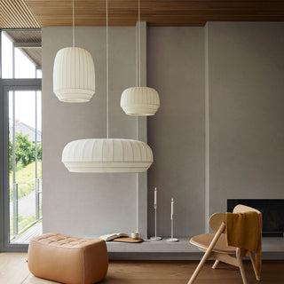 Modern living room with pendant lights, a chair, and an ottoman.