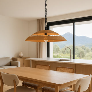 Modern kitchen with wooden dining table, chairs, and pendant light fixture.