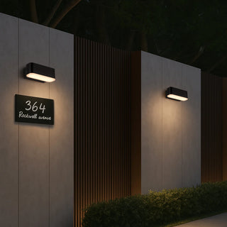 Ziron 10 Black exterior wall light illuminating modern outdoor fence