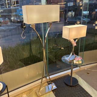 Glass table with chairs and a lamp in an indoor setting