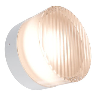 Round wall light fixture with ribbed design on a white background