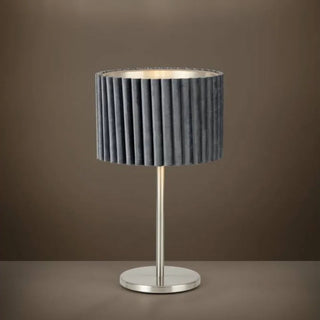 Table lamp with pleated gray shade on a brown background