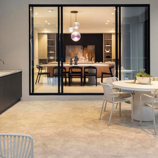 Modern kitchen and dining area with large glass doors leading to a patio.