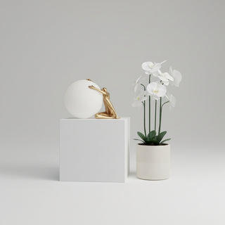 CENTO Table Lamp – opal sphere with gold sculptural base embracing the globe