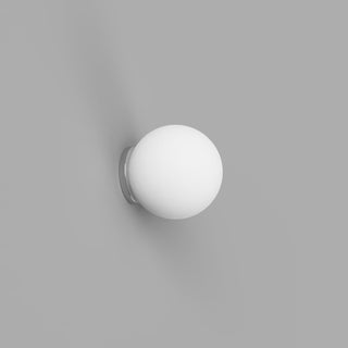 Wall-mounted light fixture with a white globe on a gray background