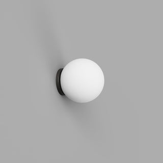 Wall-mounted spherical light fixture on a gray background