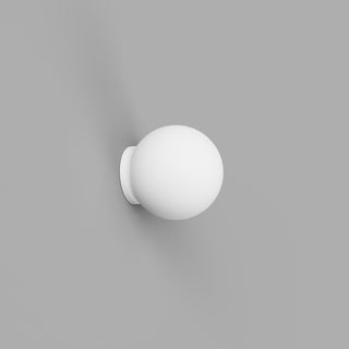 White spherical wall light fixture on a gray background