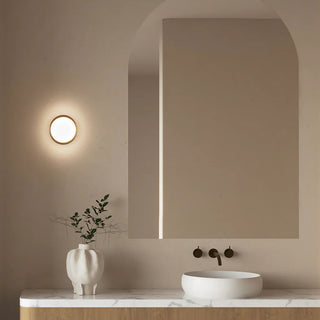 Modern bathroom with a sink, mirror, and decorative vase.