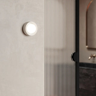 Close-up of a modern shower enclosure with a light fixture.