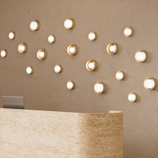 Beige reception desk with decorative wall lights in a modern interior setting