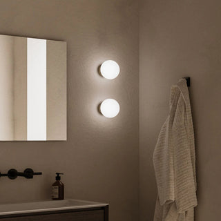 Pair of Orb Deco Wall Lights installed beside mirror in contemporary bathroom setting